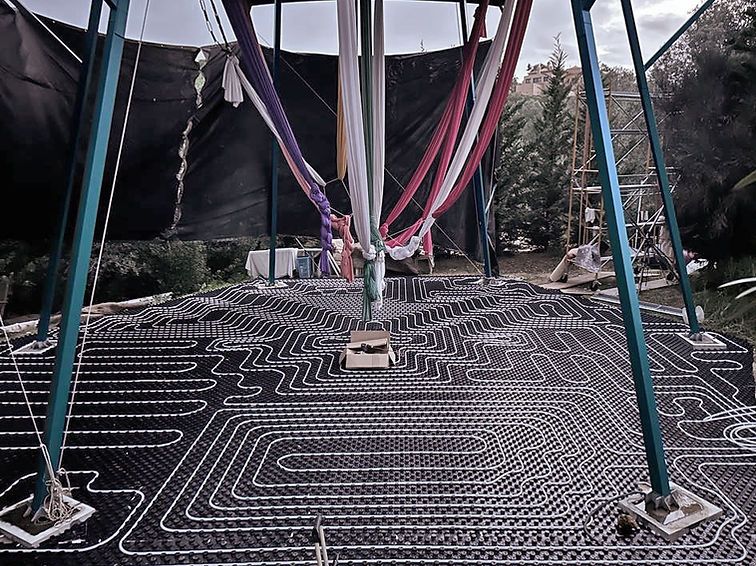 Underfloor heating pipes laid out under the rigged studio