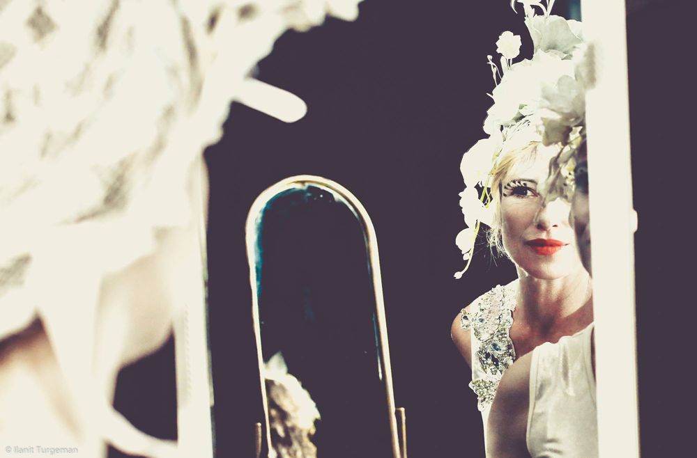 Performer in a white costume on stage