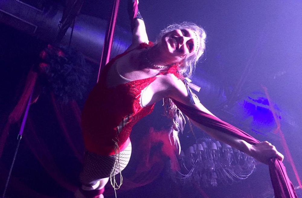 Performing on a pole under purple stage light