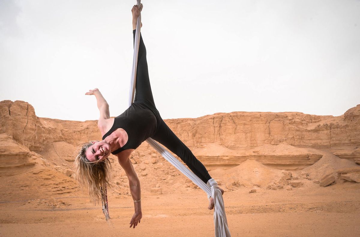 Silks pose on a rig in the desert