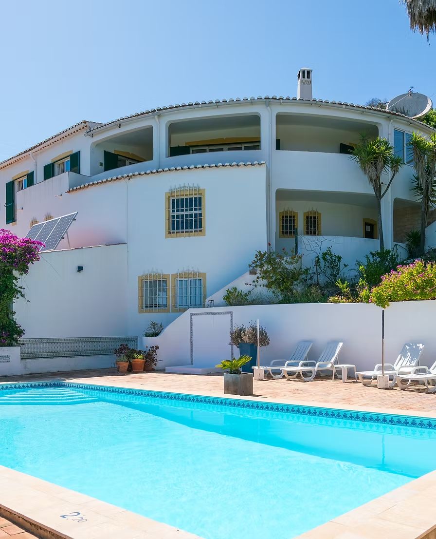 Casa Lorena, a white villa with a turquoise pool