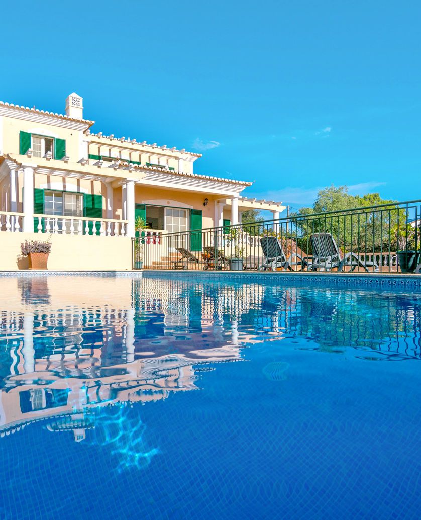 Quatro Ventos villa reflected in its blue pool