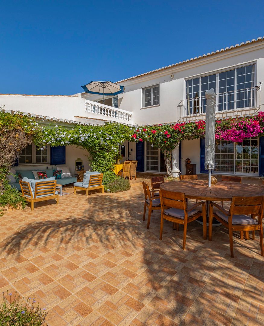 Quinta do Verao terrace with an outdoor dining table and bougainvillea