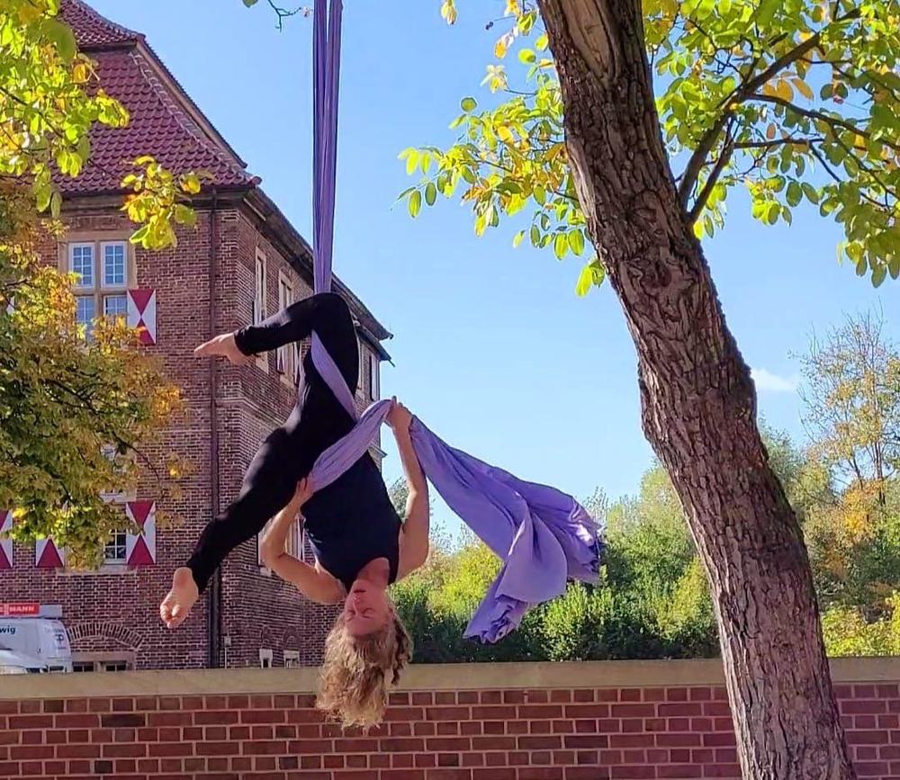 Julia Torggler inverted on aerial silks