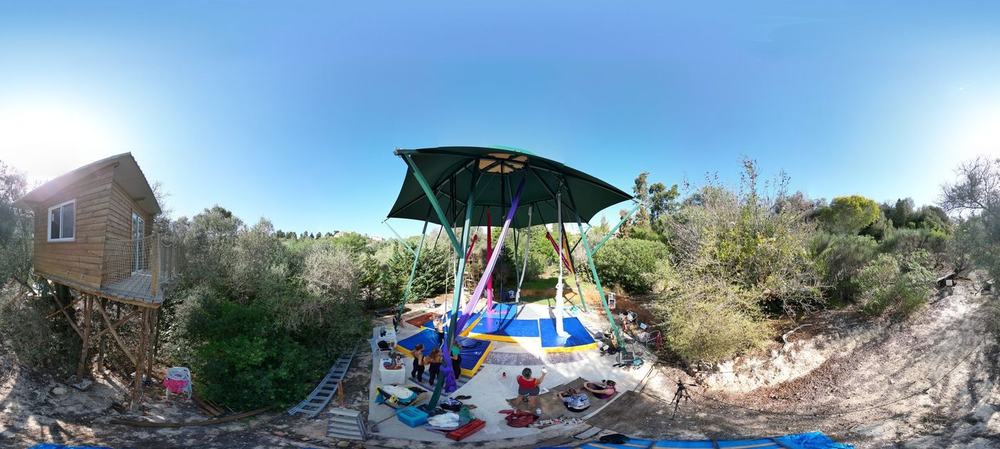 Drone view of the hexagonal aerial studio and treehouse among the trees