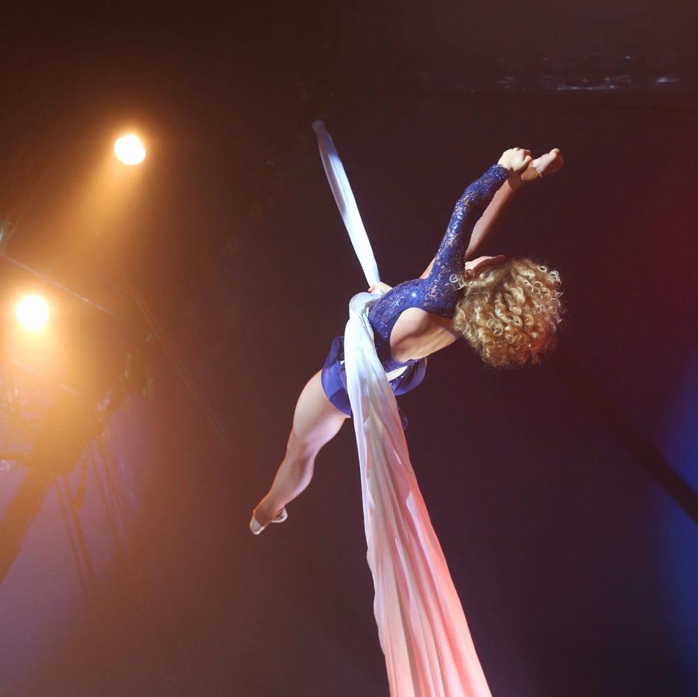 Julia Torggler performing on aerial silks on stage