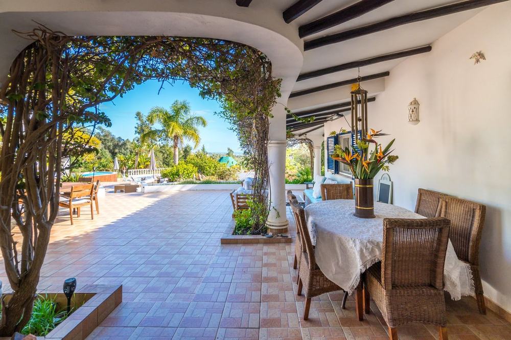 Covered terrace dining area overlooking the gardens