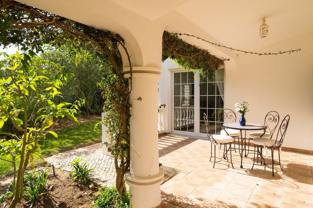 Private shaded terrace nook with a bistro table
