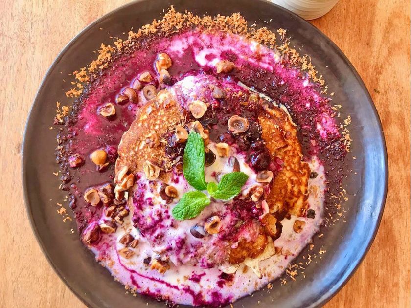 Berry yogurt bowl with nuts and mint