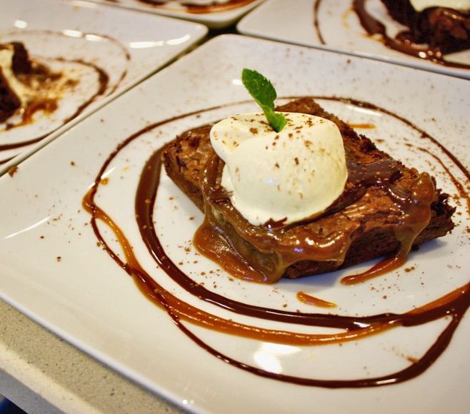 Chocolate dessert with cream and caramel sauce