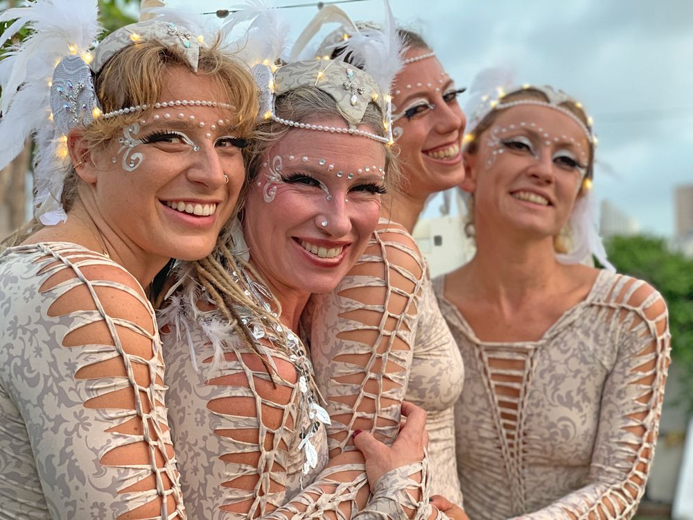 Performers in white costumes and headpieces