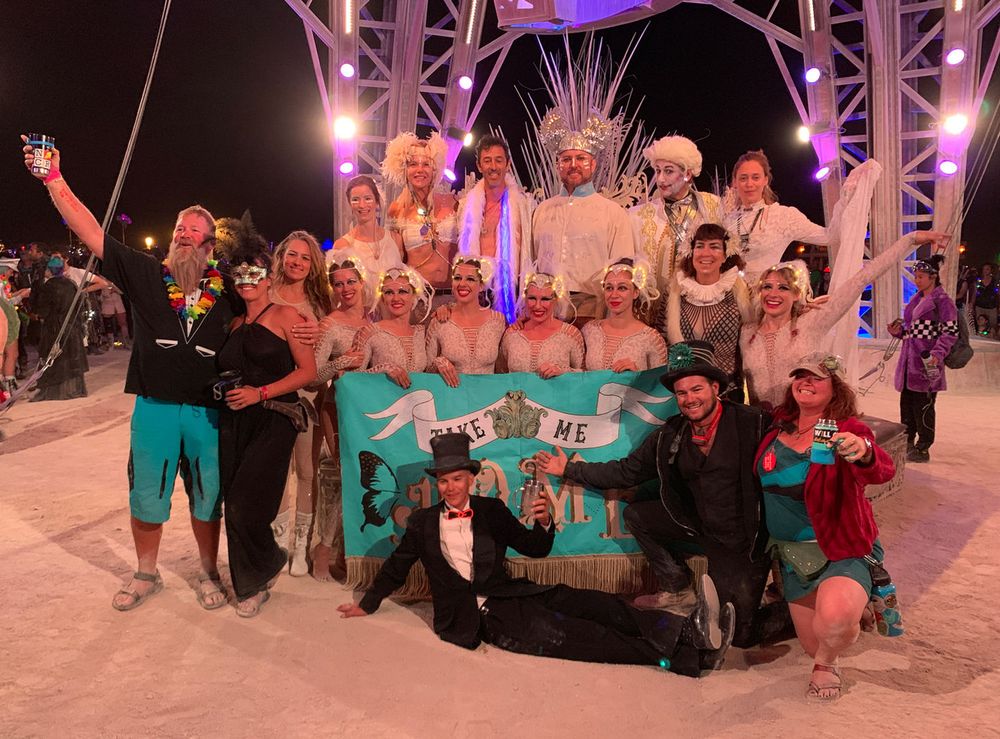 The circus crew posing with a banner