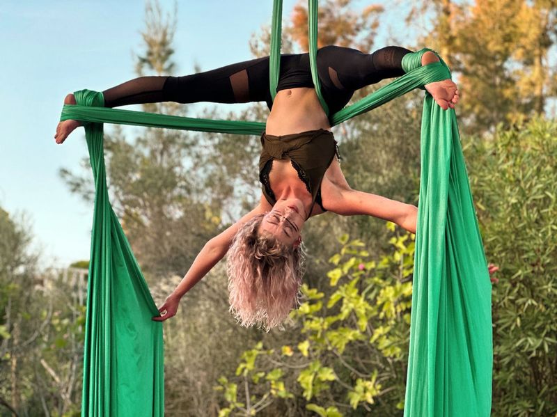 Inverted split on green silks in the garden
