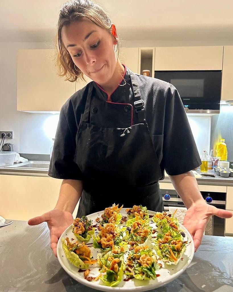 Tiffany holds freshly made salad with walnuts, local greens and cracked pepper drizzled with balsamic vinegar