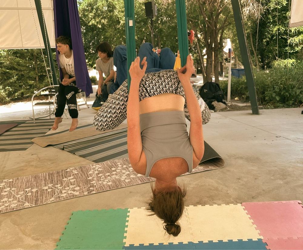 Aerial yoga benefits include inversions that increase blood flow to the brain