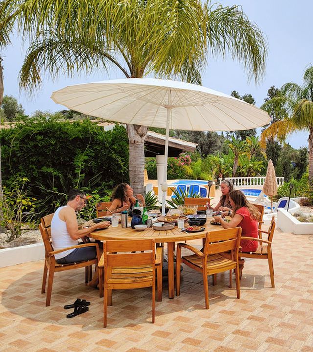 Lunch table under a parasol in the garden