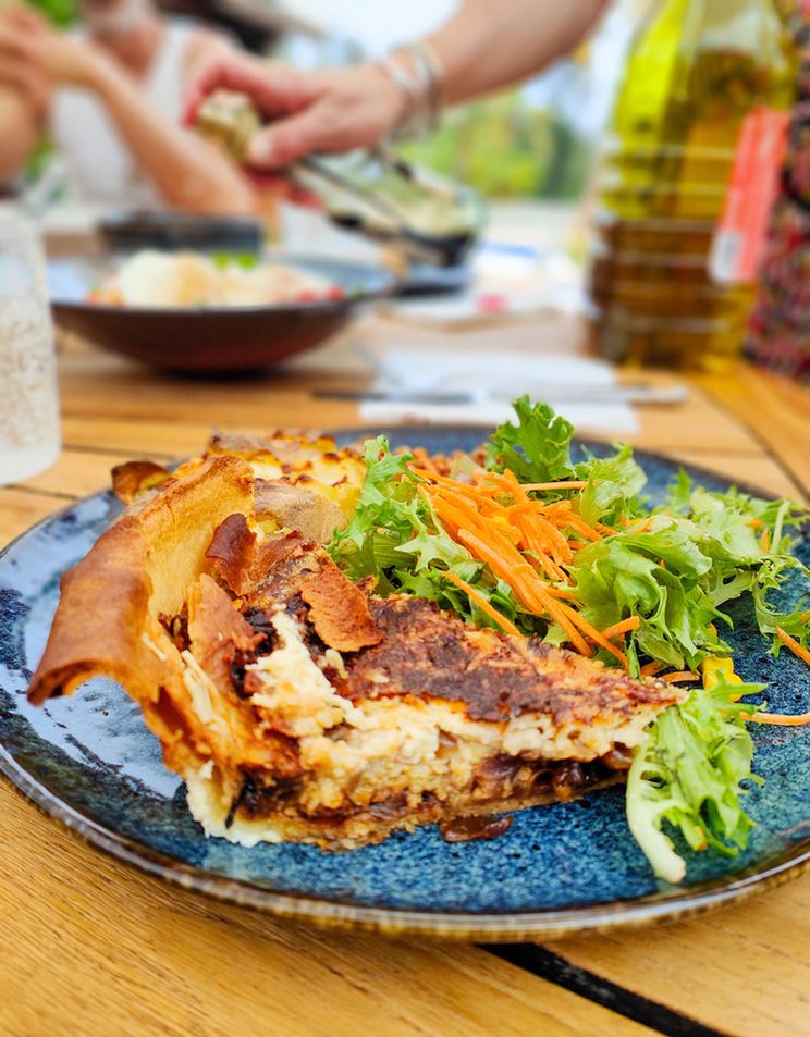 A plate of quiche and salad on the terrace