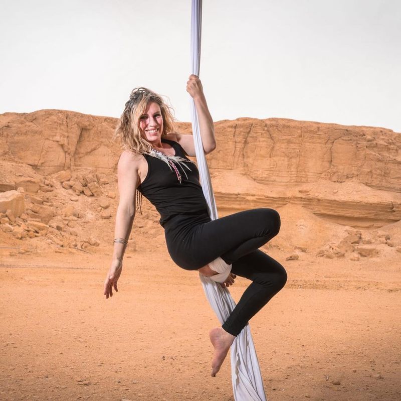 Meredith climbing white silks in the desert